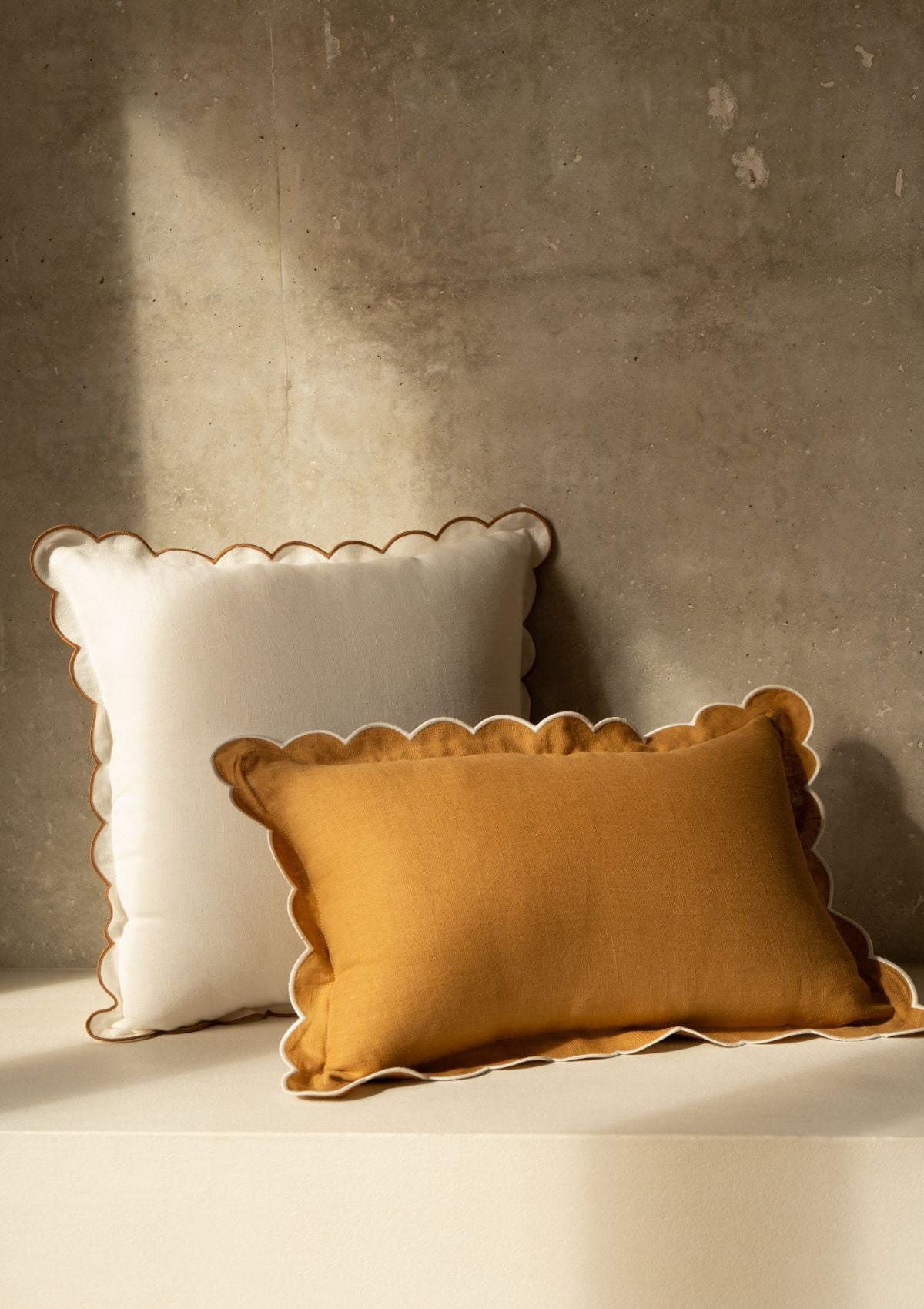 The square scalloped linen cushion in White & Yellow ocher