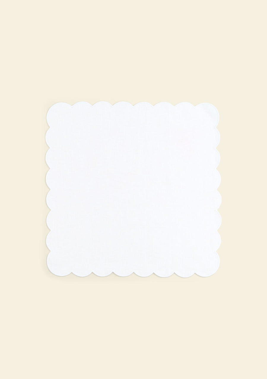 Scalloped white linen napkin