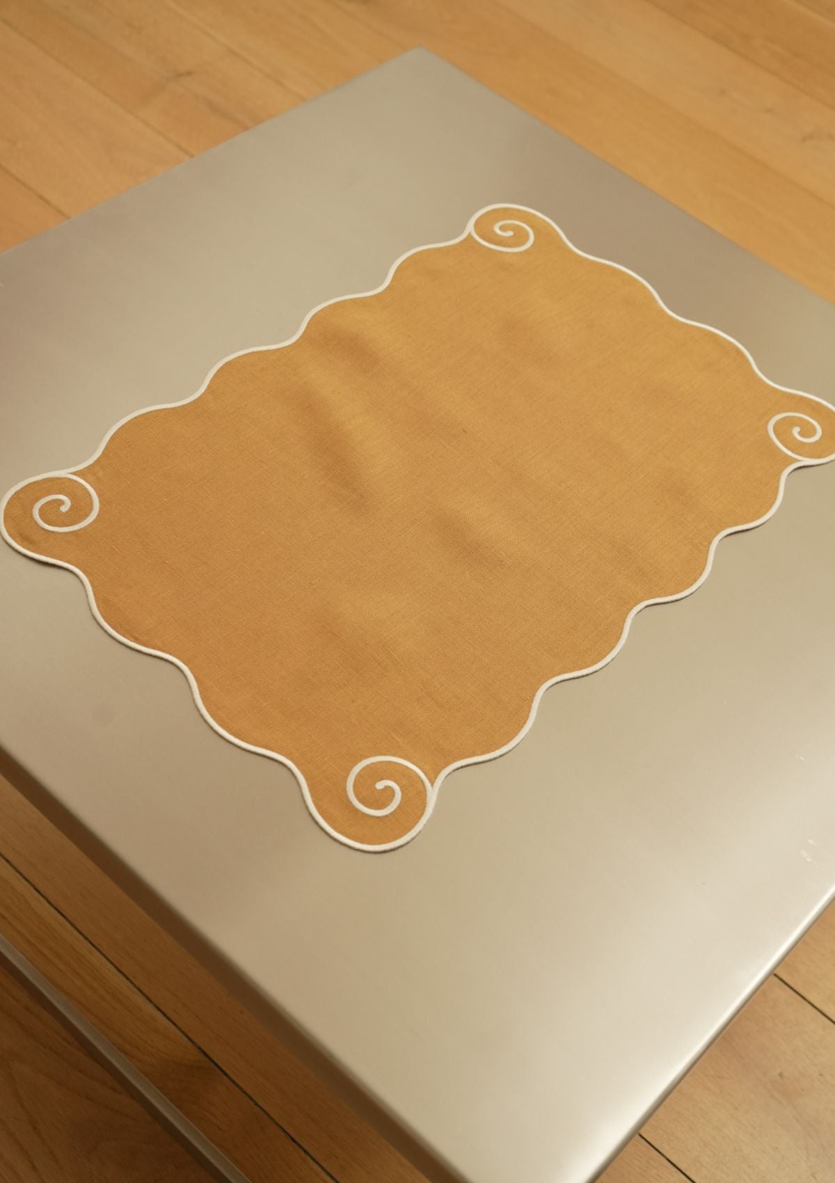 The Volute Placemat in Ochre Yellow & White Linen