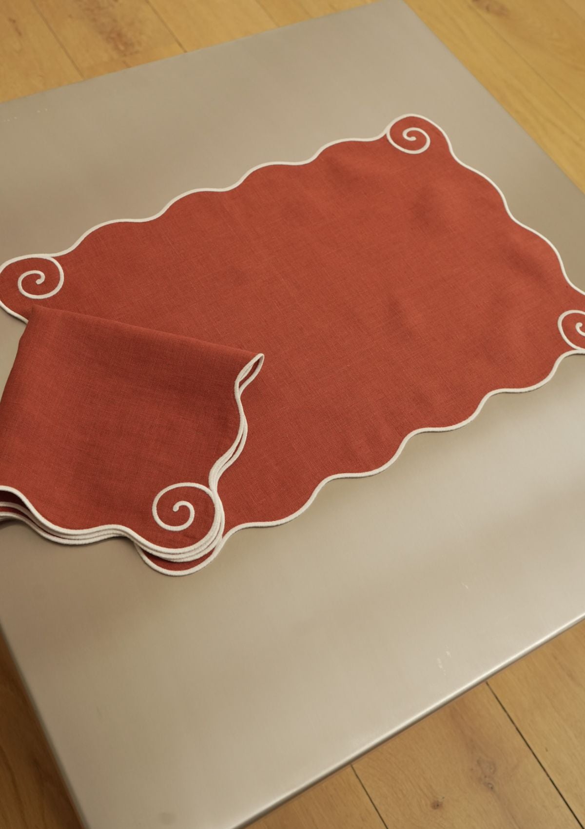 Volute Placemat in Red Ochre & White Linen