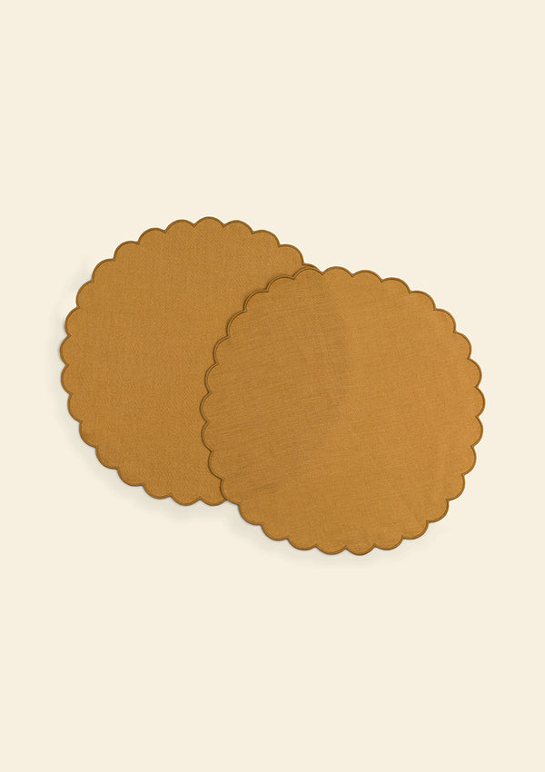 Round scalloped placemats in yellow ocher linen